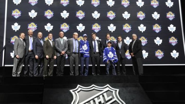 Jun 26, 2015; Sunrise, FL, USA; Mitchell Marner poses for a photo with team executives after being selected as the number four overall pick to the Toronto Maple Leafs in the first round of the 2015 NHL Draft at BB&T Center. Mandatory Credit: Steve Mitchell-USA TODAY Sports