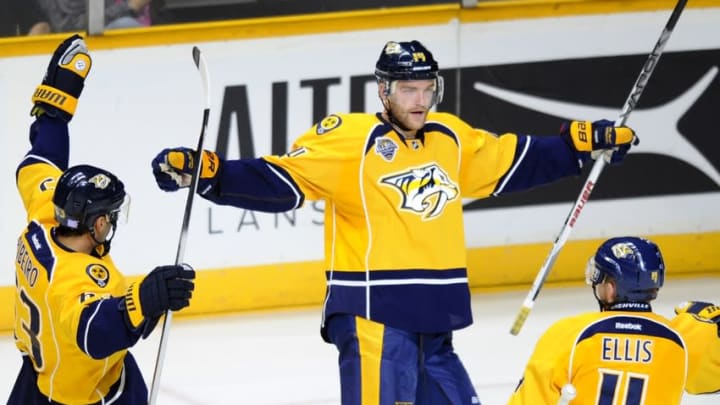 Oct 22, 2015; Nashville, TN, USA; Nashville Predators defenseman Mattias Ekholm (14) celebrates with center Mike Ribeiro (63) and defenseman Ryan Ellis (4) after scoring during the third period against the Anaheim Ducks at Bridgestone Arena. The Predators won 5-1. Mandatory Credit: Christopher Hanewinckel-USA TODAY Sports