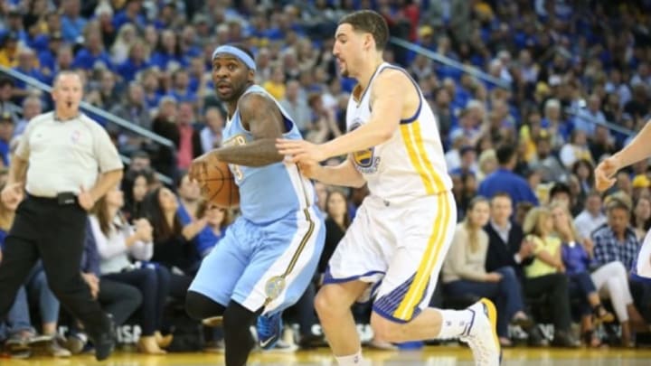 Apr 15, 2015; Oakland, CA, USA; Denver Nuggets guard Ty Lawson (3) drives in against Golden State Warriors guard Klay Thompson (11) during the second quarter at Oracle Arena. Mandatory Credit: Kelley L Cox-USA TODAY Sports