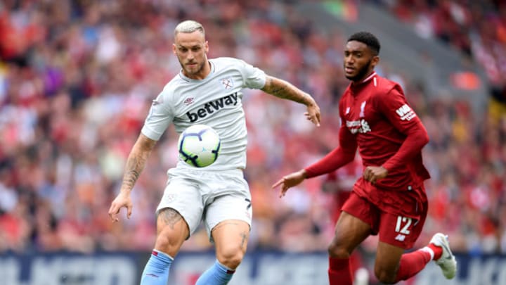 LIVERPOOL, ENGLAND - AUGUST 12: Marko Arnautovic of West Ham United controls the ball under pressure from Joe Gomez of Liverpool during the Premier League match between Liverpool FC and West Ham United at Anfield on August 12, 2018 in Liverpool, United Kingdom. (Photo by Laurence Griffiths/Getty Images)