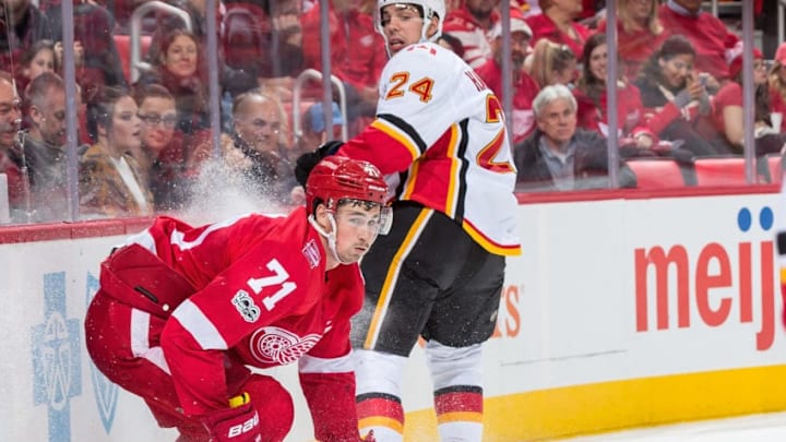 DETROIT, MI - NOVEMBER 15: Dylan Larkin #71 of the Detroit Red Wings stops behind the net next to Travis Hamonic #24 of the Calgary Flames during an NHL game at Little Caesars Arena on November 15, 2017 in Detroit, Michigan. The Red Wings defeated the Flames 8-2. (Photo by Dave Reginek/NHLI via Getty Images)