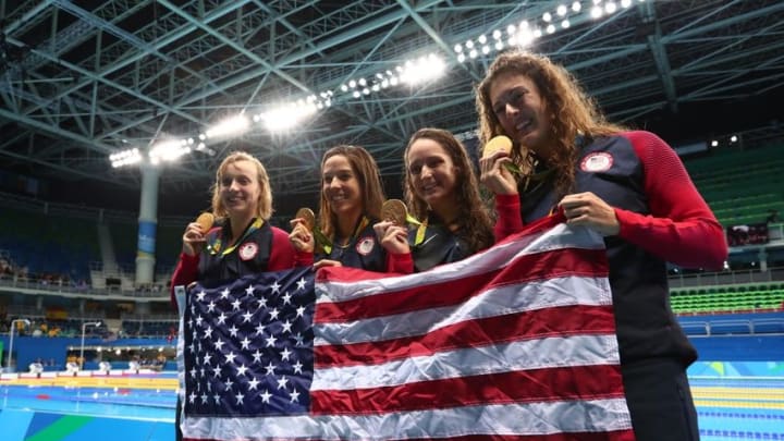 Aug 10, 2016; Rio de Janeiro, Brazil; Katie Ledecky (USA) , Allison Schmitt (USA) , Leah Smith (USA) and Maya Dirado (USA) celebrate with their gold medals after winning the gold during the women