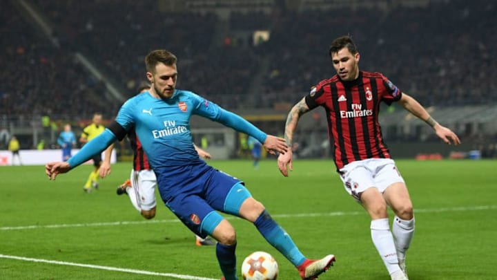 MILAN, ITALY - MARCH 08: Aaron Ramsey of Arsenal is closed down by Alessio Romagnoli of AC Milan during UEFA Europa League Round of 16 match between AC Milan and Arsenal at the San Siro on March 8, 2018 in Milan, Italy. (Photo by David Price/Arsenal FC via Getty Images)