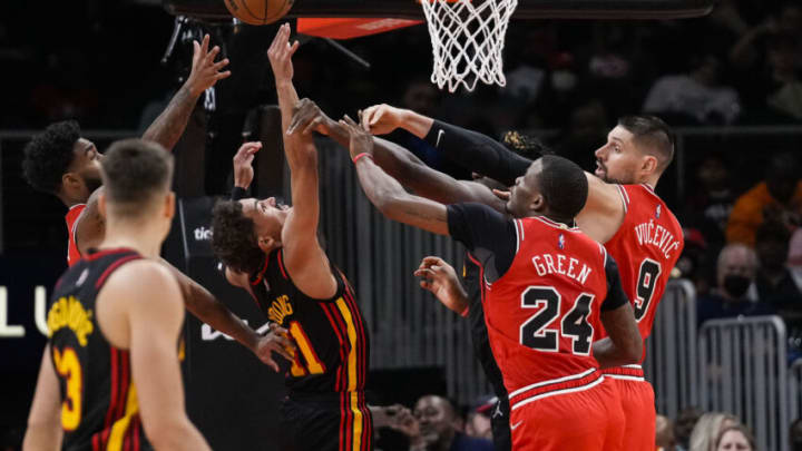 Dec 27, 2021; Atlanta, Georgia, USA; Atlanta Hawks guard Trae Young (11) and center Clint Capela (15) battle for a rebound with Chicago Bulls forward Javonte Green (24) and center Nikola Vucevic (9) during the second half at State Farm Arena. Mandatory Credit: Dale Zanine-USA TODAY Sports