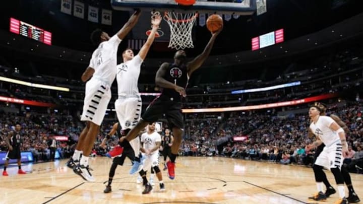 Nov 24, 2015; Denver, CO, USA; Los Angeles Clippers forward Lance Stephenson (1) shoots the ball as Denver Nuggets forward Will Barton (5) and forward Danilo Gallinari (8) defend in the third quarter at the Pepsi Center. Mandatory Credit: Isaiah J. Downing-USA TODAY Sports