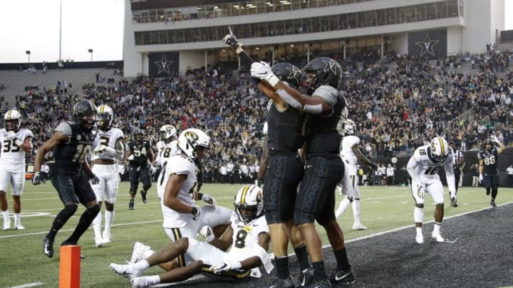 Cam Johnson #7 of the Vanderbilt Commodores celebrates with teammates after scoring the go ahead touchdown against the Missouri Tigers during the second half of a Vanderbilt 21-14 upset (Photo by Frederick Breedon/Getty Images)