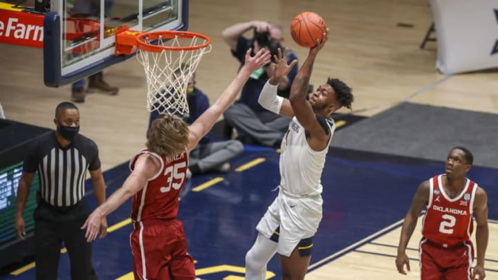 Feb 13, 2021; Morgantown, West Virginia, USA; West Virginia Mountaineers forward Derek Culver (1) shoots over Oklahoma Sooners forward Brady Manek (35) during the first half at WVU Coliseum. Mandatory Credit: Ben Queen-USA TODAY Sports