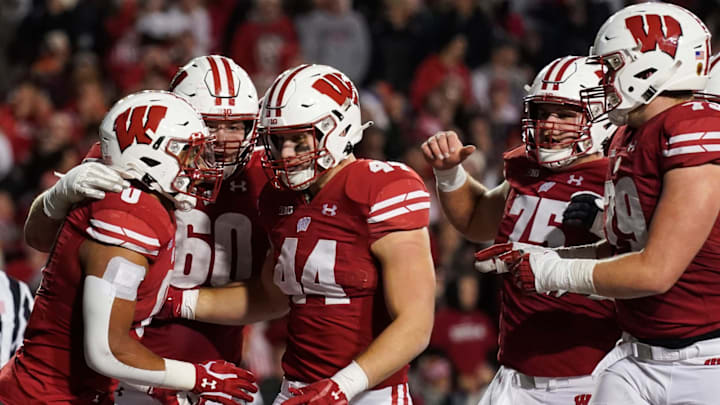 MADISON, WISCONSIN – NOVEMBER 20: Braelon Allen #0 of the Wisconsin Badgers celebrates with his teammates after scoring a touchdown in the third quarter against the Nebraska Cornhuskers at Camp Randall Stadium on November 20, 2021 in Madison, Wisconsin. (Photo by Patrick McDermott/Getty Images)