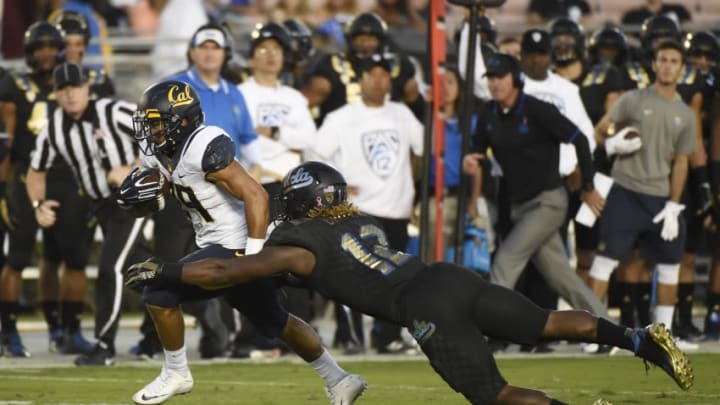 Oct 22, 2015; Pasadena, CA, USA; California Golden Bears running back Khalfani Muhammad (29) runs against UCLA Bruins linebacker Jayon Brown (12) during the first quarter at Rose Bowl. Mandatory Credit: Richard Mackson-USA TODAY Sports