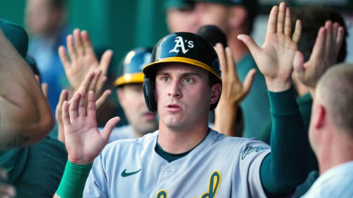 May 6, 2023; Kansas City, Missouri, USA; Oakland Athletics center fielder JJ Bleday (33) is congratulated by teammates after scoring a run during the second inning against the Kansas City Royals at Kauffman Stadium. Mandatory Credit: Jay Biggerstaff-USA TODAY Sports