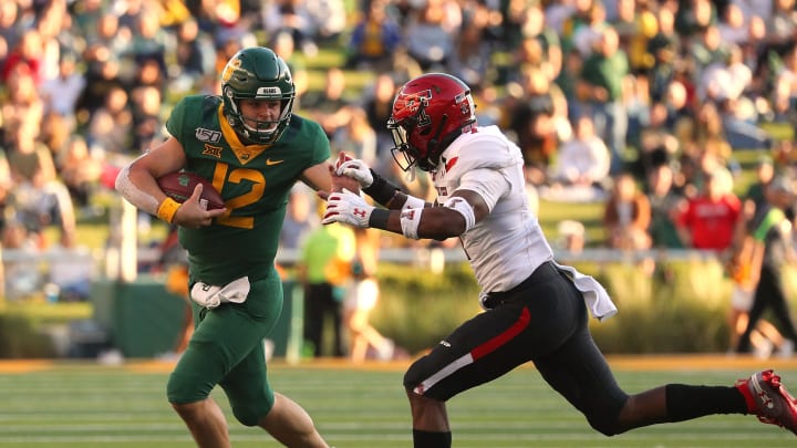 WACO, TEXAS – OCTOBER 12: Charlie Brewer #12 of the Baylor Bears is pursued by Adrian Frye #7 of the Texas Tech Red Raiders. (Photo by Richard Rodriguez/Getty Images)