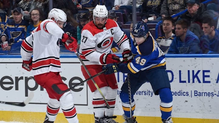 ST. LOUIS, MO - DECEMBER 30: Justin Faulk #27 of the Carolina Hurricanes and Ivan Barbashev #49 of the St. Louis Blues battle for control of the puck at Scottrade Center on December 30, 2017 in St. Louis, Missouri. (Photo by Joe Puetz/NHLI via Getty Images)