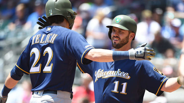 ATLANTA, GEORGIA - MAY 19: Christian Yelich #22 of the Milwaukee Brewers celebrates with Mike Moustakas #11 after hitting a home run in the first inning against the Atlanta Braves at SunTrust Park on May 19, 2019 in Atlanta, Georgia. (Photo by Logan Riely/Getty Images)