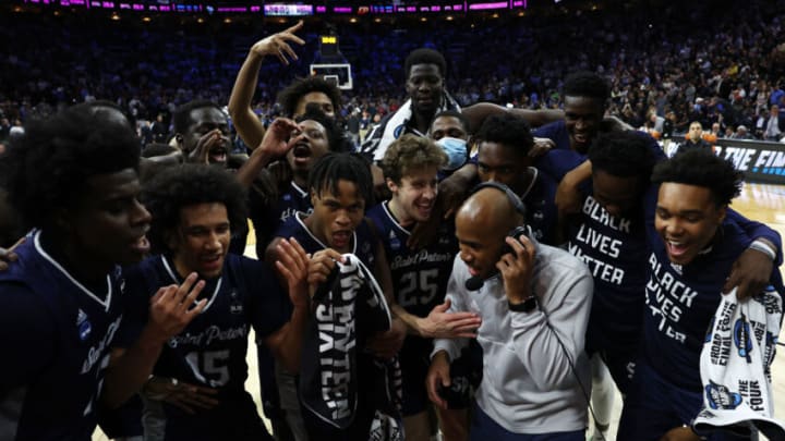 PHILADELPHIA, PENNSYLVANIA - MARCH 25: St. Peter's Peacocks players celebrate with head coach Shaheen Holloway after defeating the Purdue Boilermakers 67-64 in the Sweet Sixteen round game of the 2022 NCAA Men's Basketball Tournament at Wells Fargo Center on March 25, 2022 in Philadelphia, Pennsylvania. (Photo by Patrick Smith/Getty Images)