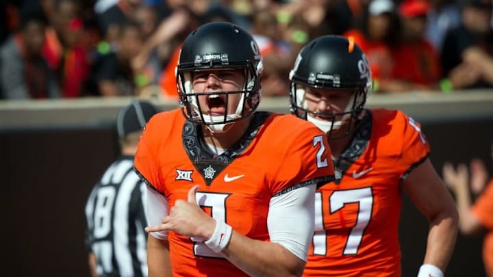 Oct 29, 2016; Stillwater, OK, USA; Oklahoma State Cowboys quarterback Mason Rudolph (2) reacts after scoring a rushing touchdown against the West Virginia Mountaineers during the second half at Boone Pickens Stadium. Cowboys won 37-20. Mandatory Credit: Rob Ferguson-USA TODAY Sports