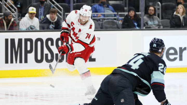 SEATTLE, WASHINGTON - NOVEMBER 24: Jaccob Slavin #74 of the Carolina Hurricanes shoots against Jamie Oleksiak #24 of the Seattle Kraken during the second period at Climate Pledge Arena on November 24, 2021 in Seattle, Washington. (Photo by Steph Chambers/Getty Images)