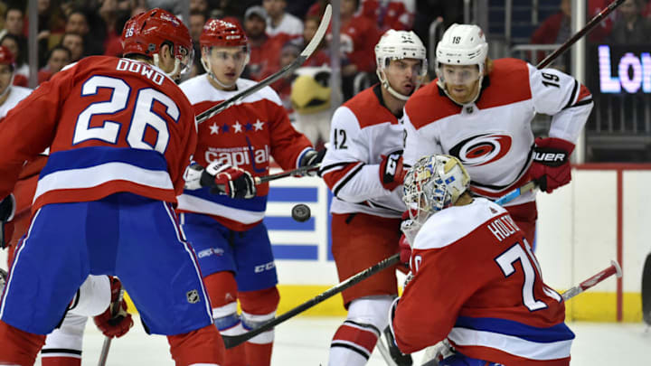 WASHINGTON, DC - MARCH 26: Carolina Hurricanes defenseman Dougie Hamilton (19) and Washington Capitals goalie Braden Holtby (70) watcha puck fly toward the net during the Carolina Hurricanes vs. Washington Capitals NHL game March 26, 2019 at Capital One Arena in Washington, D.C.. (Photo by Randy Litzinger/Icon Sportswire via Getty Images)