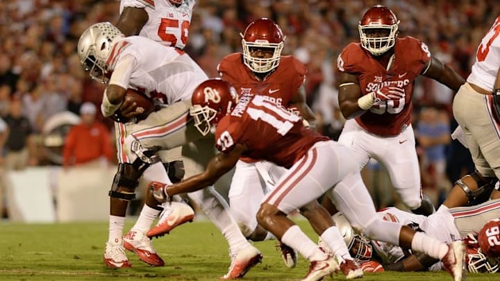 Sep 17, 2016; Norman, OK, USA; Ohio State Buckeyes quarterback J.T. Barrett (16) is tackled by Oklahoma Sooners safety Steven Parker (10) in the first quarter at Gaylord Family - Oklahoma Memorial Stadium. Mandatory Credit: Mark D. Smith-USA TODAY Sports