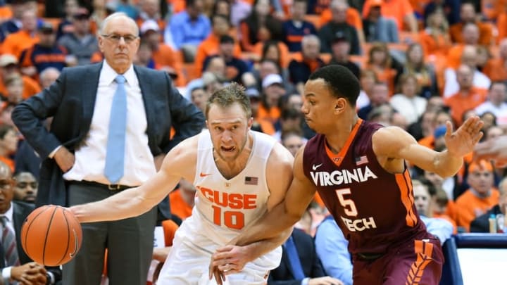 Feb 2, 2016; Syracuse, NY, USA; Syracuse Orange guard Trevor Cooney (10) drives to the basket against the defense of Virginia Tech Hokies guard Justin Robinson (5) during the second half at the Carrier Dome. The Orange won 68-60 in overtime. Mandatory Credit: Rich Barnes-USA TODAY Sports