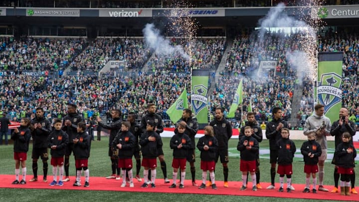 SEATTLE, WA - MARCH 4: Members of Los Angeles FC stand on the field with youth escorts before the start of a match against the Seattle Sounders at CenturyLink Field on March 4, 2018 in Seattle, Washington. Los Angeles FC won 1-0. (Photo by Stephen Brashear/Getty Images)