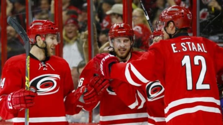 Jan 12, 2016; Raleigh, NC, USA; Carolina Hurricanes forward Kris Versteeg (32) celebrates with forward Eric Staal (12), forward Elias Lindholm (16), and defensemen Brett Pesce (54) after scoring a goal against the Pittsburgh Penguins in the second period at PNC Arena. Mandatory Credit: James Guillory-USA TODAY Sports