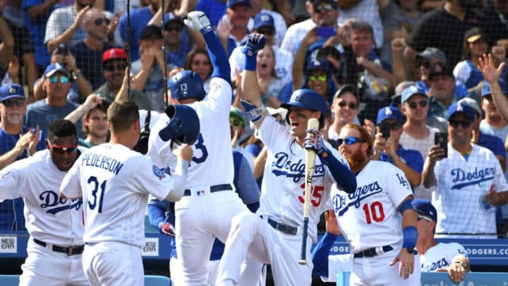 LOS ANGELES, CA - OCTOBER 01: Yasiel Puig #66, Joc Pederson #31, Cody Bellinger #35 and Justin Turner #10 celebrate with Max Muncy #13 of the Los Angeles Dodgers after he hit a two run home run in the fifth inning of the game against the Colorado Rockies at Dodger Stadium on October 1, 2018 in Los Angeles, California. (Photo by Jayne Kamin-Oncea/Getty Images)