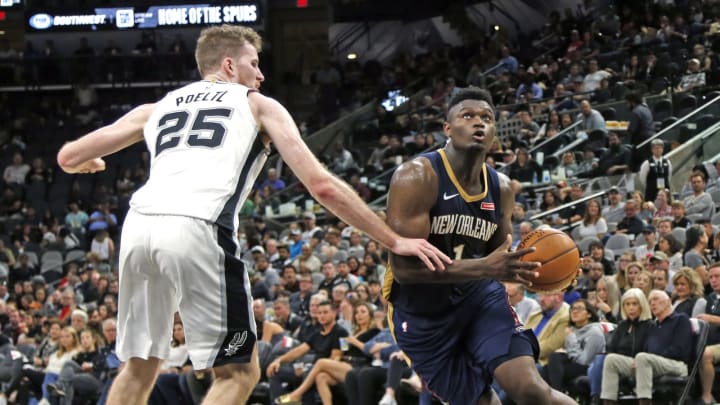 SAN ANTONIO,TX – OCTOBER 13: Zion Williamson #1 of the New Orleans Pelicans drives on Jakob Poeltl #25 of the San Antonio Spurs in a pre-season game at AT&T Center on October 13 , 2019 in San Antonio, Texas. NOTE TO USER: User expressly acknowledges and agrees that , by downloading and or using this photograph, User is consenting to the terms and conditions of the Getty Images License Agreement. (Photo by Ronald Cortes/Getty Images)
