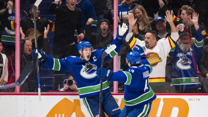Mar 11, 2022; Vancouver, British Columbia, CAN; Vancouver Canucks forward Bo Horvat (53) and defenseman Quinn Hughes (43) celebrate HorvatÕs second goal of the game against the Washington Capitals in the third period at Rogers Arena. Capitals won 4-3 in overtime. Mandatory Credit: Bob Frid-USA TODAY Sports