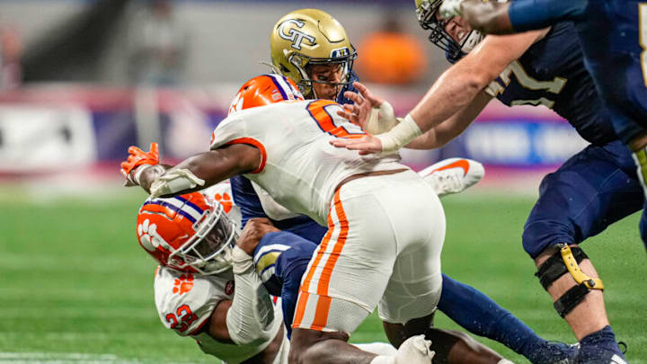 Sep 5, 2022; Atlanta, Georgia, USA; Georgia Tech Yellow Jackets running back Dontae Smith (4) is tackled by Clemson Tigers linebacker Trenton Simpson (22) and linebacker Barrett Carter (0) during the first half at Mercedes-Benz Stadium. Mandatory Credit: Dale Zanine-USA TODAY Sports