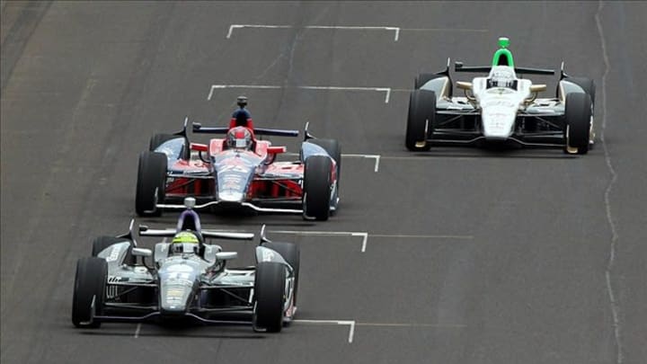 May 26, 2013; Indianapolis, IN, USA; IndyCar Series driver Tony Kanaan (11) leads Marco Andretti (25) and Ed Carpenter (20) during the 2013 Indianapolis 500 at Indianapolis Motor Speedway. Mandatory Credit: Brian Spurlock-USA TODAY Sports