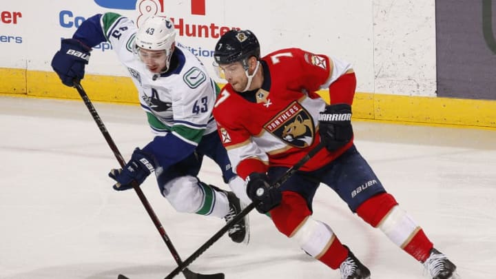 SUNRISE, FL - JANUARY 09: Colton Sceviour #7 of the Florida Panthers crosses sticks with Quinn Hughes #43 of the Vancouver Canucks at the BB&T Center on January 9, 2020 in Sunrise, Florida. (Photo by Eliot J. Schechter/NHLI via Getty Images)