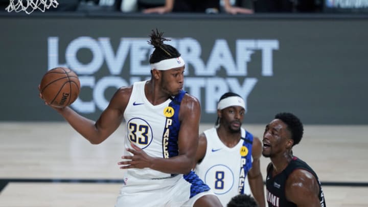 LAKE BUENA VISTA, FLORIDA - AUGUST 22: Myles Turner #33 of the Indiana Pacers pulls down a rebound over Bam Adebayo #13 of the Miami Heat during the second half of Game Three of the first round of the playoffs at the AdventHealth Arena at the ESPN Wide World Of Sports Complex on August 22, 2020 in Lake Buena Vista, Florida. NOTE TO USER: User expressly acknowledges and agrees that, by downloading and or using this photograph, User is consenting to the terms and conditions of the Getty Images License Agreement. (Photo by Ashley Landis-Pool/Getty Images)