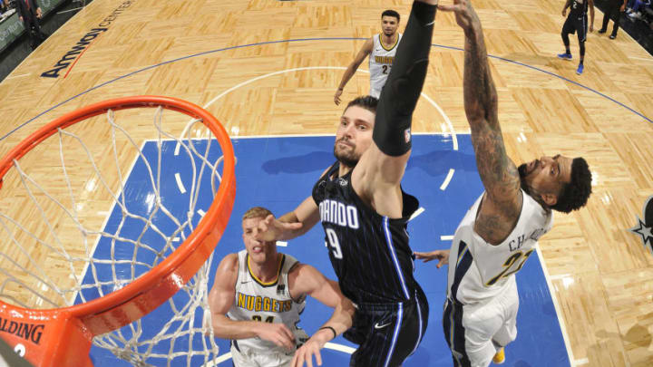 ORLANDO, FL - DECEMBER 8: Nikola Vucevic #9 of the Orlando Magic drives to the basket against the Denver Nuggets on December 8, 2017 at the Amway Center in Orlando, Florida. NOTE TO USER: User expressly acknowledges and agrees that, by downloading and or using this Photograph, user is consenting to the terms and conditions of the Getty Images License Agreement. Mandatory Copyright Notice: Copyright 2017 NBAE (Photo by Fernando Medina/NBAE via Getty Images)