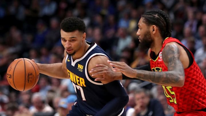 DENVER, CO - NOVEMBER 15: Jamal Murray #27 of the Denver Nuggets drives against Deandre' Bembry #95 the Atlanta Hawks at the Pepsi Center on November 15, 2018 in Denver, Colorado. NOTE TO USER: User expressly acknowledges and agrees that, by downloading and or using this photograph, User is consenting to the terms and conditions of the Getty Images License Agreement. (Photo by Matthew Stockman/Getty Images)