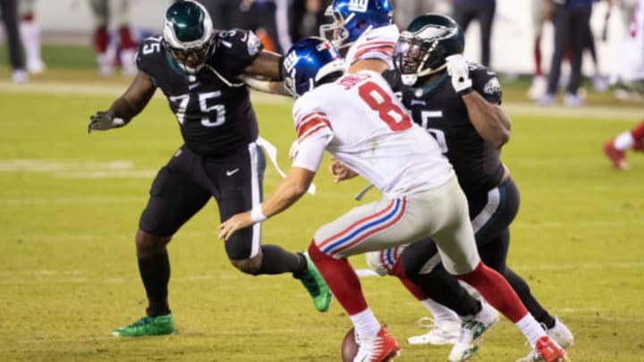 Oct 22, 2020; Philadelphia, Pennsylvania, USA; New York Giants quarterback Daniel Jones (8) fumbles the ball while in front of the rush of Philadelphia Eagles defensive end Vinny Curry (75) and defensive end Brandon Graham (55) during the fourth quarter at Lincoln Financial Field. Mandatory Credit: Bill Streicher-USA TODAY Sports