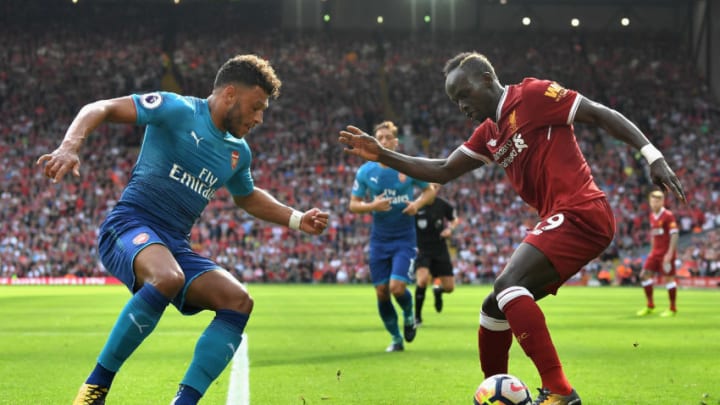 LIVERPOOL, ENGLAND - AUGUST 27: Sadio Mane of Liverpool and Alex Oxlade-Chamberlain of Arsenal battle for possession during the Premier League match between Liverpool and Arsenal at Anfield on August 27, 2017 in Liverpool, England. (Photo by Michael Regan/Getty Images)