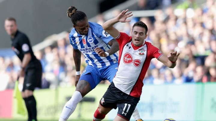 BRIGHTON, ENGLAND - OCTOBER 29: Gaetan Bong of Brighton and Hove Albion and Dusan Tadic of Southampton battle for possession during the Premier League match between Brighton and Hove Albion and Southampton at Amex Stadium on October 29, 2017 in Brighton, England. (Photo by Henry Browne/Getty Images)