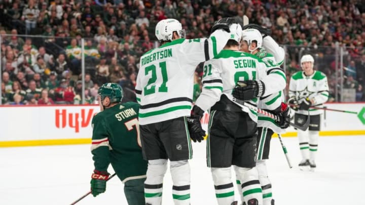 Mar 6, 2022; Saint Paul, Minnesota, USA; Dallas Stars left wing Jason Robertson (21) and center Tyler Seguin (91) congratulate center Joe Pavelski (16) on scoring the tying goal in the first period at Xcel Energy Center. Mandatory Credit: Matt Blewett-USA TODAY Sports