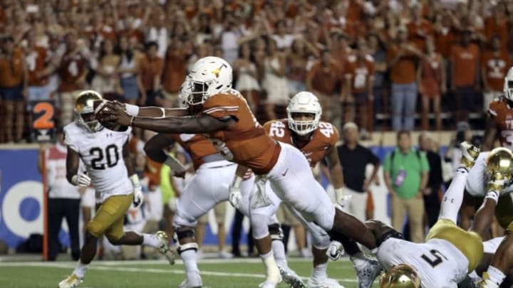 Sep 4, 2016; Austin, TX, USA; Texas Longhorns quarterback Tyrone Swoopes (18) dives and scores the game winning touchdown past Notre Dame Fighting Irish linebacker Nyles Morgan (5) in overtime at Darrell K Royal-Texas Memorial Stadium. Mandatory Credit: Kevin Jairaj-USA TODAY Sports