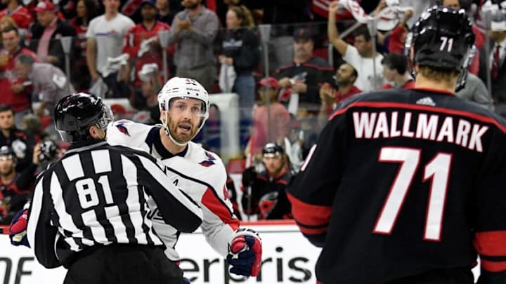 RALEIGH, NORTH CAROLINA - APRIL 22: Linesman s #81 restrains Brooks Orpik #44 of the Washington Capitals from fighting with Lucas Wallmark #71 of the Carolina Hurricanes in the first period of Game Six of the Eastern Conference First Round during the 2019 NHL Stanley Cup Playoffs at PNC Arena on April 22, 2019 in Raleigh, North Carolina. (Photo by Grant Halverson/Getty Images)