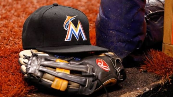 Jun 4, 2014; St. Petersburg, FL, USA; Miami Marlins hat and glove lay in the dugout against the Tampa Bay Rays at Tropicana Field. Mandatory Credit: Kim Klement-USA TODAY Sports