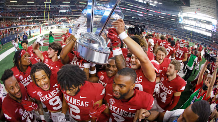 ARLINGTON, TX - SEPTEMBER 25: The Arkansas Razorbacks celebrate with the Southwest Classic championship trophy following the teams 20-10 win over Texas A&M Aggies at AT&T Stadium on September 25, 2021 in Arlington, Texas. (Photo by Ron Jenkins/Getty Images)