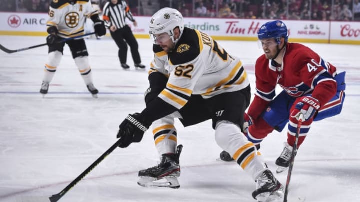 MONTREAL, QC - NOVEMBER 26: Sean Kuraly #52 of the Boston Bruins skates the puck against Joel Armia #40 of the Montreal Canadiens during the first period at the Bell Centre on November 26, 2019 in Montreal, Canada. (Photo by Minas Panagiotakis/Getty Images)