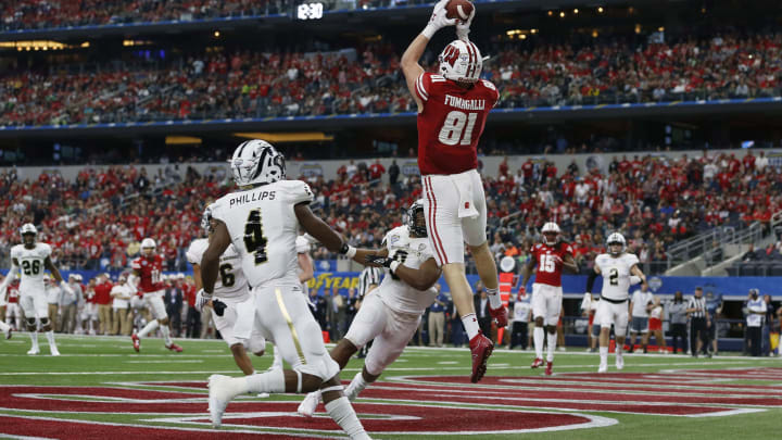 Jan 2, 2017; Arlington, TX, USA; Wisconsin Badgers tight end Troy Fumagalli (81) catches a touchdown pass in front of Western Michigan Broncos cornerback Darius Phillips (4) and linebacker Caleb Bailey (8) in the fourth quarter at AT&T Stadium. Wisconsin won 24-16. Mandatory Credit: Tim Heitman-USA TODAY Sports
