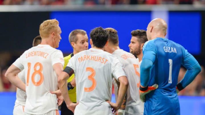 ATLANTA, GA MAY 9: Atlanta’s Jeff Larentowicz (18) and Michael Parkhurst (3) argue with referee Mark Gieger (center) after goalkeeper Brad Guzan (1) was given a red card during the match between Atlanta United and Kansas City on May 9, 2018 at Mercedes-Benz Stadium in Atlanta, GA. Sporting Kansas City defeated Atlanta United FC 2 0. (Photo by Rich von Biberstein/Icon Sportswire via Getty Images)