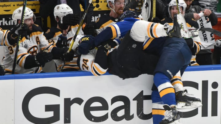 ST. LOUIS, MO - JUN 01: Boston Bruins leftwing Jake DeBrusk (74) and St. Louis Blues defenseman Joel Edmundson (6) collide near the Bruins team bench during Game 3 of the Stanley Cup Final between the Boston Bruins and the St. Louis Blues, on June 01, 2019, at Enterprise Center, St. Louis, Mo. (Photo by Keith Gillett/Icon Sportswire via Getty Images)