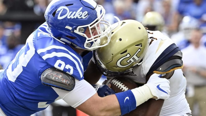 DURHAM, NORTH CAROLINA – OCTOBER 12: Ben Frye #93 of the Duke Blue Devils tackles Jordan Mason #27 of the Georgia Tech Yellow Jackets during the second half of their game at Wallace Wade Stadium on October 12, 2019 in Durham, North Carolina. Duke won 41-23. (Photo by Grant Halverson/Getty Images)