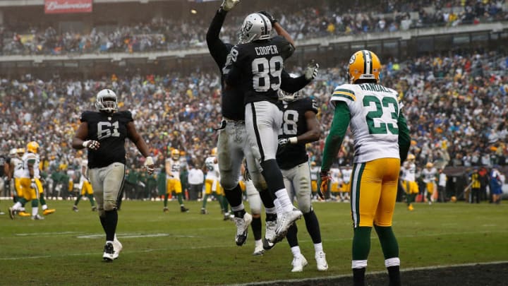 OAKLAND, CA - DECEMBER 20: Wide receiver Amari Cooper #89 of the Oakland Raiders celebrates catching a touchdown pass against cornerback Damarious Randall #23 of the Green Bay Packers in the third quarter at O.co Coliseum on December 20, 2015 in Oakland, California. (Photo by Lachlan Cunningham/Getty Images)