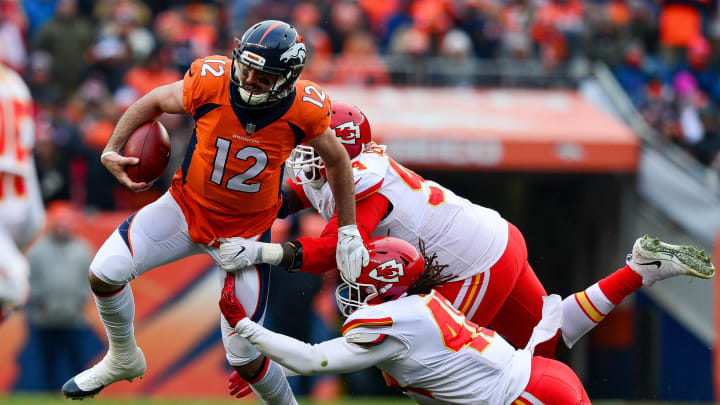 DENVER, CO – DECEMBER 31: Quarterback Paxton Lynch #12 of the Denver Broncos is tackled by inside linebacker Terrance Smith #48 and defensive tackle Jarvis Jenkins #94 of the Kansas City Chiefs scrambles against the Kansas City Chiefs in the second quarter of a game at Sports Authority Field at Mile High on December 31, 2017 in Denver, Colorado. (Photo by Dustin Bradford/Getty Images)