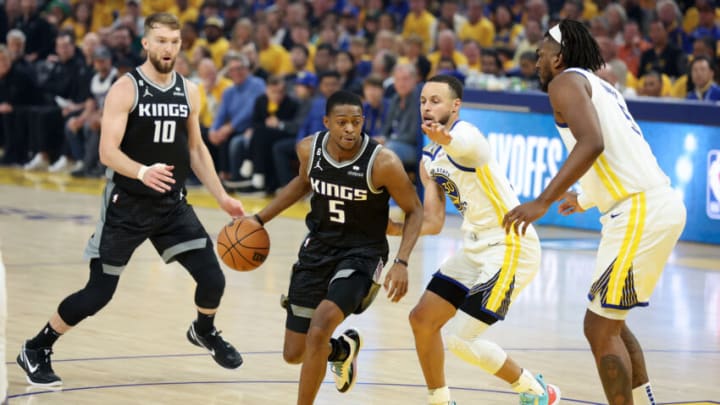 SAN FRANCISCO, CALIFORNIA - APRIL 23: De'Aaron Fox #5 of the Sacramento Kings is guarded by Stephen Curry #30 of the Golden State Warriors in the first half of Game Four of the Western Conference First Round Playoffs at Chase Center on April 23, 2023 in San Francisco, California. NOTE TO USER: User expressly acknowledges and agrees that, by downloading and or using this photograph, User is consenting to the terms and conditions of the Getty Images License Agreement. (Photo by Ezra Shaw/Getty Images) SAN FRANCISCO, CALIFORNIA - APRIL 23: De'Aaron Fox #5 of the Sacramento Kings is guarded by Stephen Curry #30 of the Golden State Warriors in the first half of Game Four of the Western Conference First Round Playoffs at Chase Center on April 23, 2023 in San Francisco, California. NOTE TO USER: User expressly acknowledges and agrees that, by downloading and or using this photograph, User is consenting to the terms and conditions of the Getty Images License Agreement. (Photo by Ezra Shaw/Getty Images)